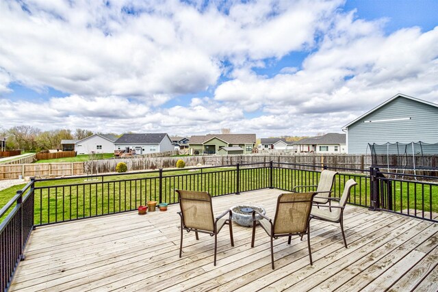 320 Hawthorne Cir, Gilbert, IA 50105 - deck with a fenced backyard, an outdoor fire pit, a yard, and a residential view