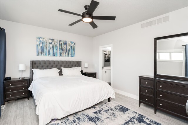 bedroom featuring visible vents, a ceiling fan, connected bathroom, light wood-style floors, and baseboards