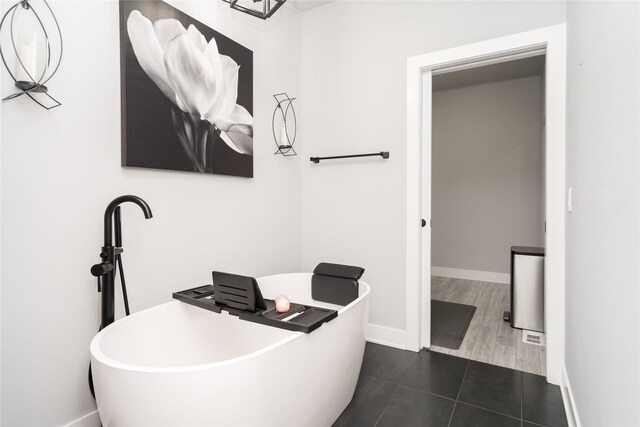interior space featuring baseboards and dark tile patterned floors
