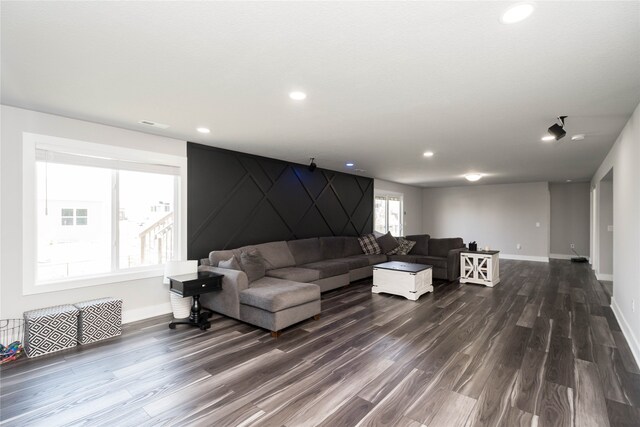 living room featuring baseboards, dark wood-style flooring, and recessed lighting