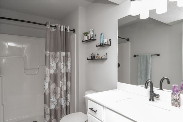 bathroom with toilet, vanity, and a shower with curtain
