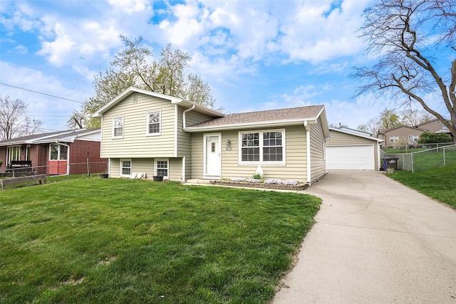 tri-level home with fence, an outdoor structure, a front yard, and a detached garage