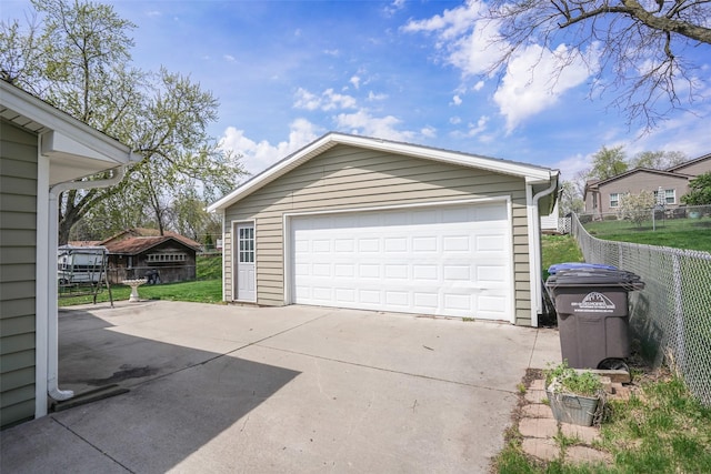 detached garage featuring fence