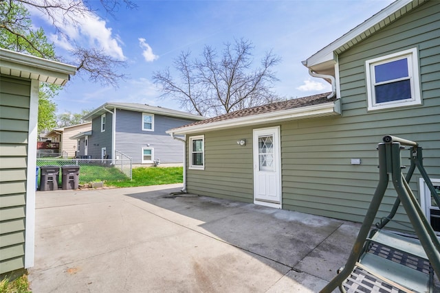 rear view of house featuring fence and a patio area