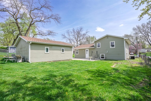 back of property with a yard, a patio, and fence private yard