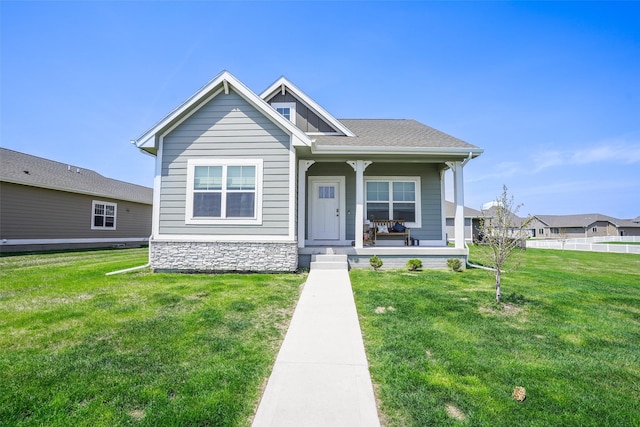 2802 SW Prairie Trail Pkwy, Ankeny, IA 50023 - view of front facade featuring stone siding, a front yard, and covered porch
