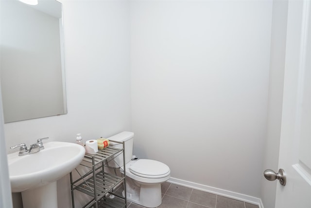 2802 SW Prairie Trail Pkwy, Ankeny, IA 50023 - bathroom with tile patterned floors, baseboards, toilet, and a sink