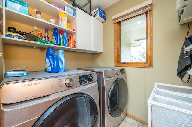 914 NE 9th St, Ankeny, IA 50021 - clothes washing area with baseboards, cabinet space, and washer and clothes dryer