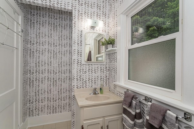 bathroom featuring vanity and wallpapered walls