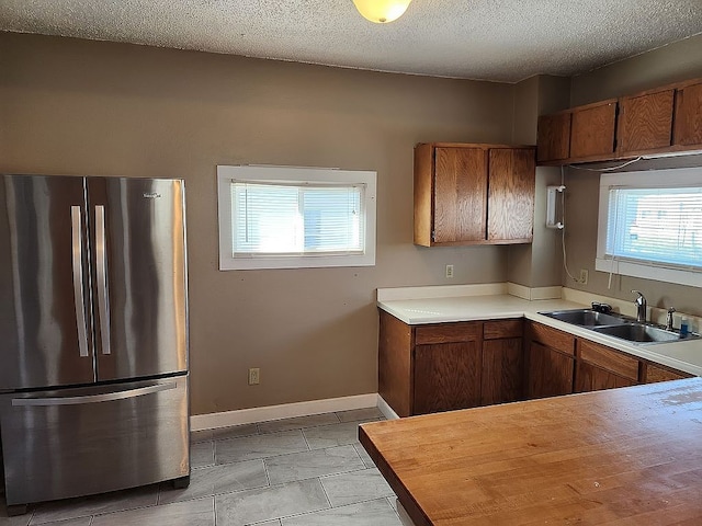 946 Miller Ave, Iowa City, IA 52246 - kitchen with plenty of natural light, light countertops, freestanding refrigerator, and a sink