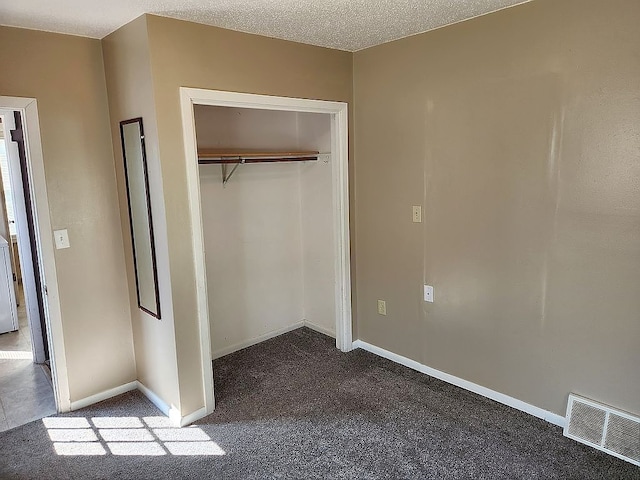 946 Miller Ave, Iowa City, IA 52246 - unfurnished bedroom with dark carpet, visible vents, baseboards, and a closet