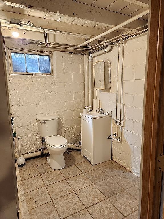 946 Miller Ave, Iowa City, IA 52246 - bathroom featuring vanity, toilet, and tile patterned flooring