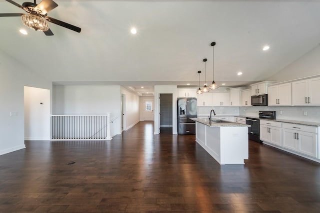 kitchen with decorative backsplash, black appliances, open floor plan, dark wood finished floors, and a ceiling fan