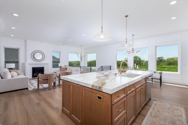 18284 Baxter Pl, Clive, IA 50325 - kitchen with a sink, a chandelier, light wood finished floors, a center island, and recessed lighting