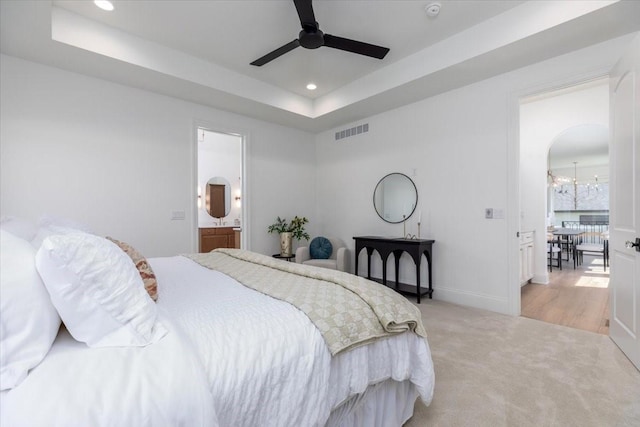 18284 Baxter Pl, Clive, IA 50325 - bedroom with light carpet, baseboards, a raised ceiling, recessed lighting, and connected bathroom