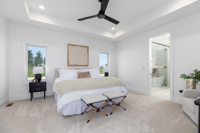 18284 Baxter Pl, Clive, IA 50325 - bedroom with light colored carpet, a raised ceiling, baseboards, recessed lighting, and connected bathroom