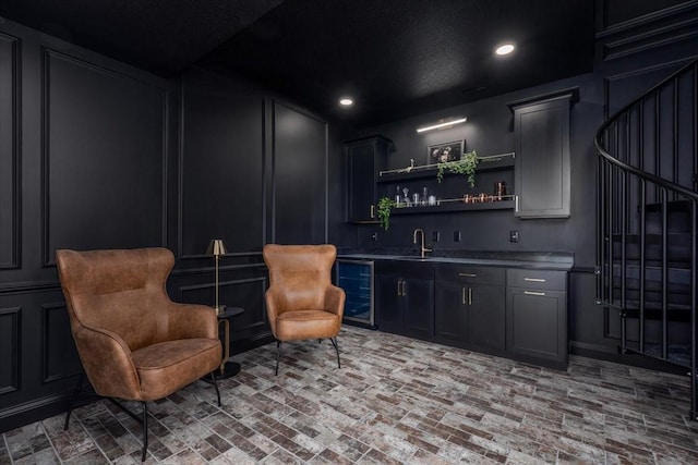 18284 Baxter Pl, Clive, IA 50325 - indoor wet bar with beverage cooler, brick flooring, recessed lighting, and a decorative wall