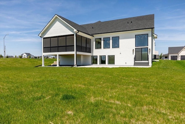 18284 Baxter Pl, Clive, IA 50325 - back of house with a yard, a sunroom, a shingled roof, and central AC