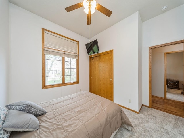 bedroom featuring baseboards, ceiling fan, carpet floors, and a closet