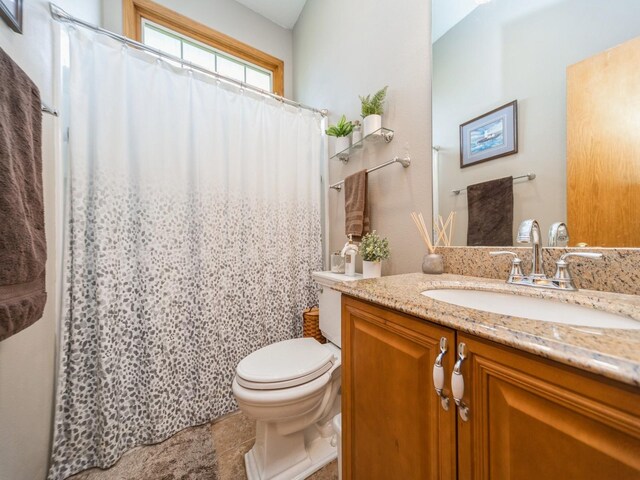 bathroom with tile patterned floors, toilet, a shower with curtain, and vanity