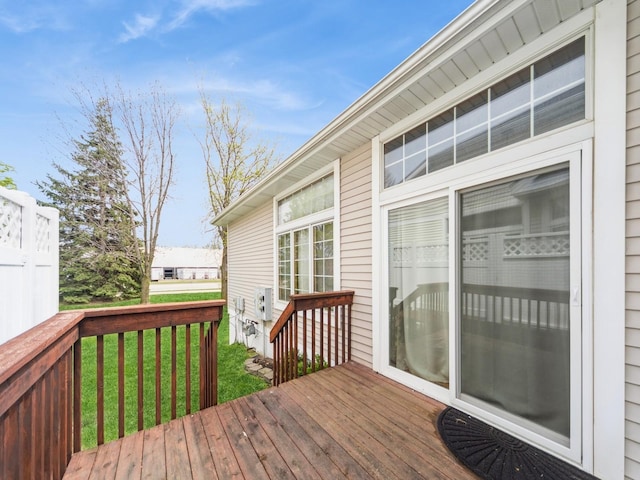 wooden deck with a lawn