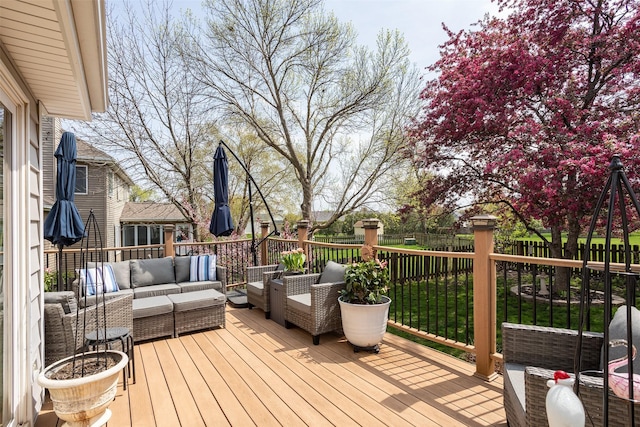 wooden deck featuring outdoor lounge area and fence