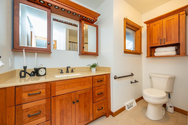 bathroom featuring visible vents, baseboards, toilet, tile patterned floors, and vanity