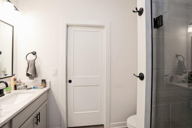 6635 NE 9th Ct, Des Moines, IA 50313 - bathroom featuring toilet, a stall shower, and vanity
