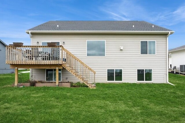 6635 NE 9th Ct, Des Moines, IA 50313 - back of house with stairs, a deck, a shingled roof, a lawn, and central AC unit