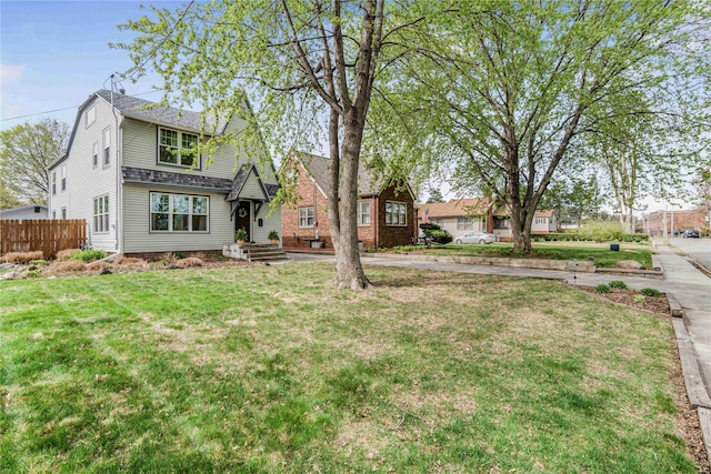 exterior space featuring a yard and fence