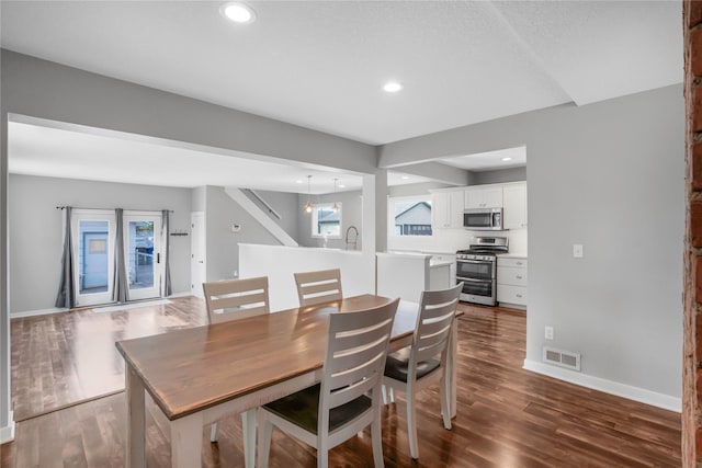 4010 Fagen Dr, Des Moines, IA 50310 - dining area with dark wood-style floors, baseboards, recessed lighting, and stairs