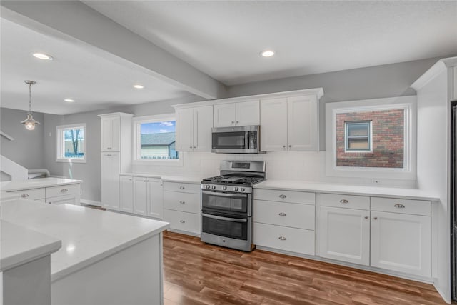 kitchen with white cabinetry, tasteful backsplash, appliances with stainless steel finishes, and light countertops