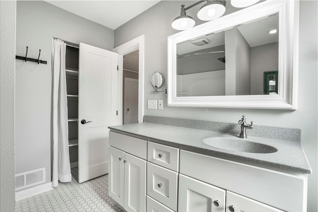 bathroom with tile patterned floors, visible vents, and vanity