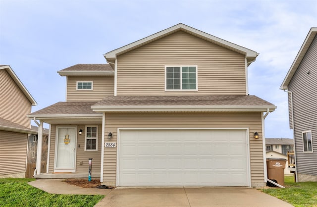 2884 Park Pl, Norwalk, IA 50211 - traditional home with concrete driveway, an attached garage, and a shingled roof