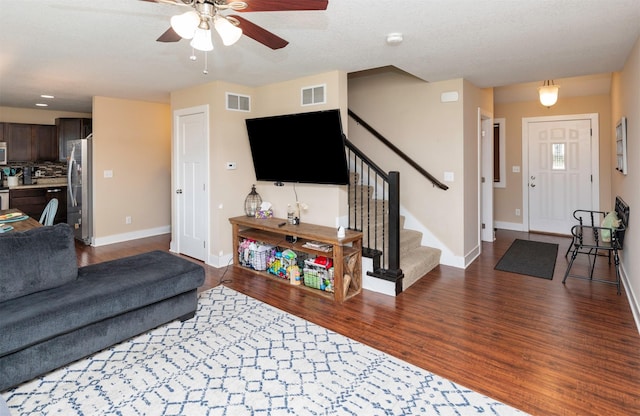 2884 Park Pl, Norwalk, IA 50211 - living area with wood finished floors, stairway, baseboards, and ceiling fan