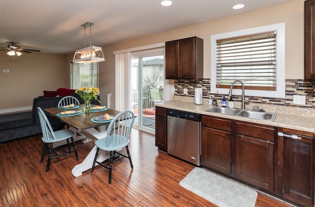 2884 Park Pl, Norwalk, IA 50211 - kitchen featuring dishwasher, a sink, light countertops, dark wood-type flooring, and recessed lighting