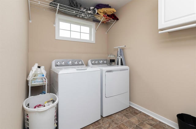 2884 Park Pl, Norwalk, IA 50211 - laundry room featuring cabinet space, washer and dryer, and stone finish floors
