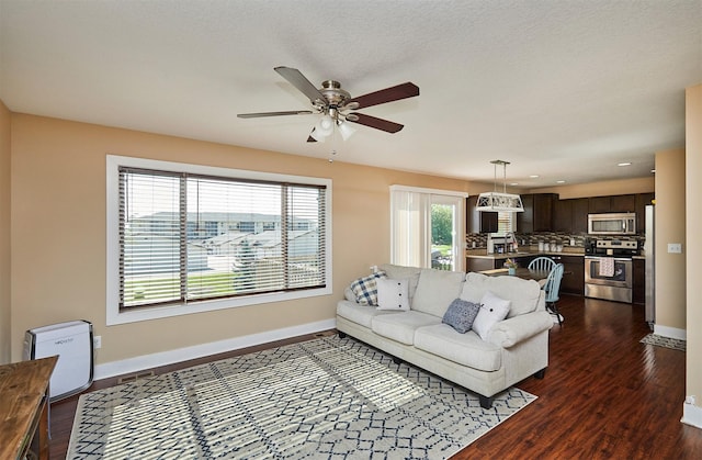 2884 Park Pl, Norwalk, IA 50211 - living area with dark wood-style flooring, ceiling fan, and recessed lighting
