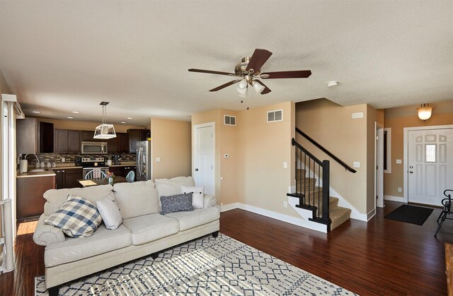 2884 Park Pl, Norwalk, IA 50211 - living room with dark wood-type flooring, ceiling fan, stairs, and recessed lighting