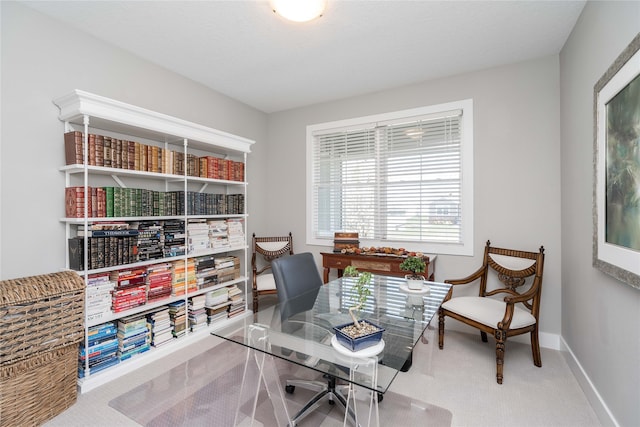 carpeted home office featuring baseboards