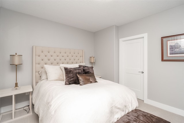 carpeted bedroom featuring baseboards