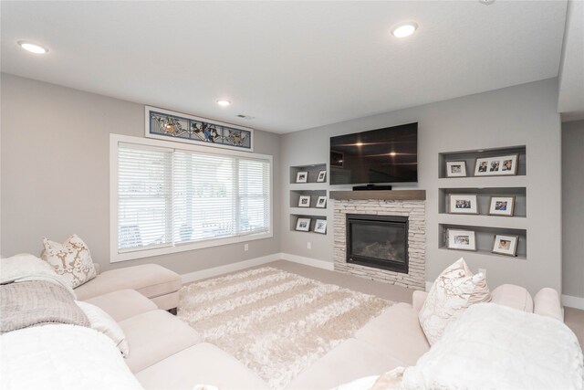carpeted living area with baseboards, recessed lighting, and a fireplace