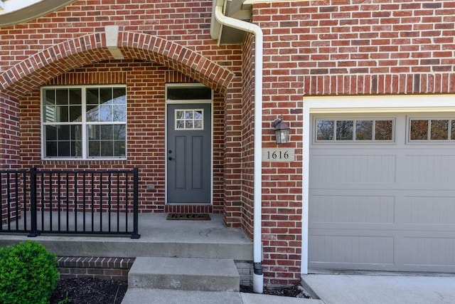 1616 Park Ave, Des Moines, IA 50315 - entrance to property with brick siding, concrete driveway, and a garage