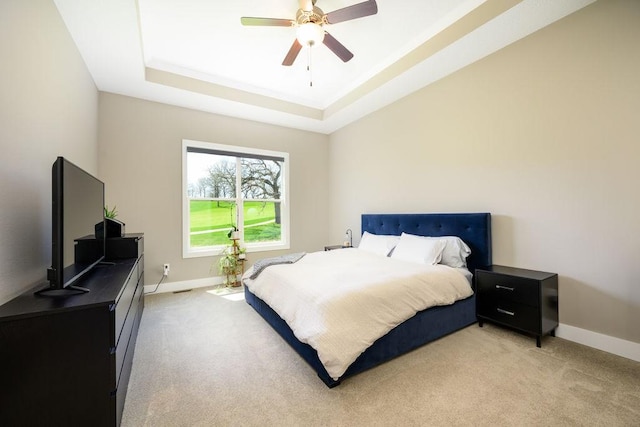 1616 Park Ave, Des Moines, IA 50315 - bedroom featuring a tray ceiling, light colored carpet, and ceiling fan