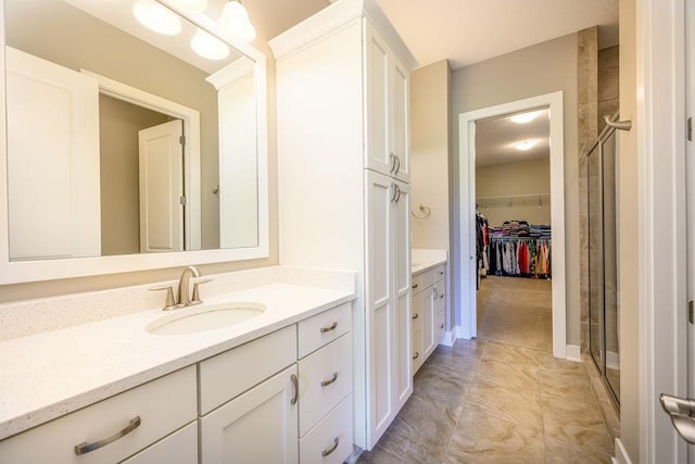 1616 Park Ave, Des Moines, IA 50315 - full bathroom featuring vanity, a walk in closet, and a shower stall