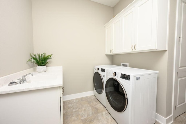 1616 Park Ave, Des Moines, IA 50315 - laundry room with cabinet space, independent washer and dryer, and light stone finish floors