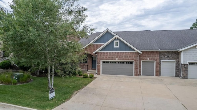 1616 Park Ave, Des Moines, IA 50315 - view of front of property with a front lawn, board and batten siding, brick siding, concrete driveway, and an attached garage