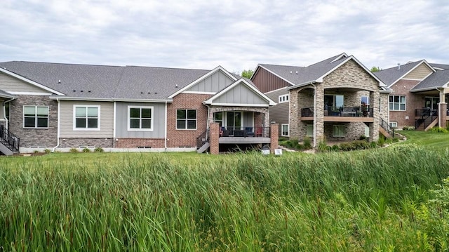 1616 Park Ave, Des Moines, IA 50315 - back of house with stairs, board and batten siding, and brick siding