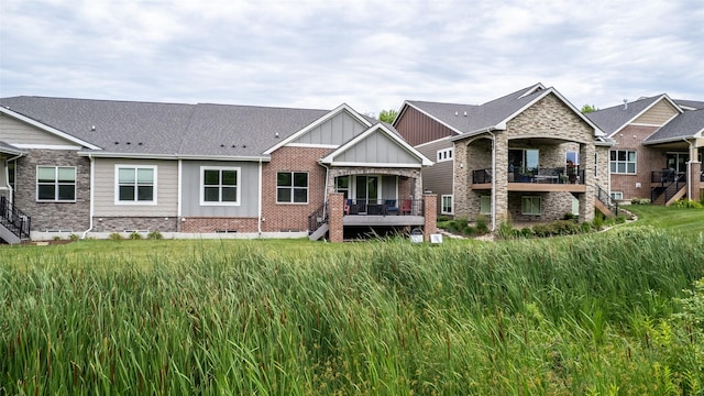 1616 Park Ave, Des Moines, IA 50315 - back of property with stairway, board and batten siding, and brick siding