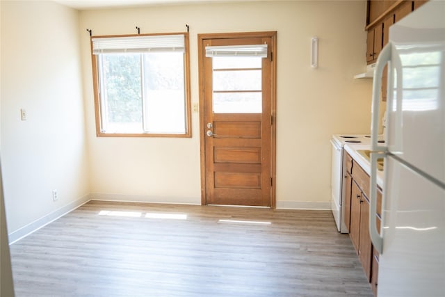 180 1st St, Gilbert, IA 50105 - kitchen with baseboards, light wood-style flooring, and white appliances